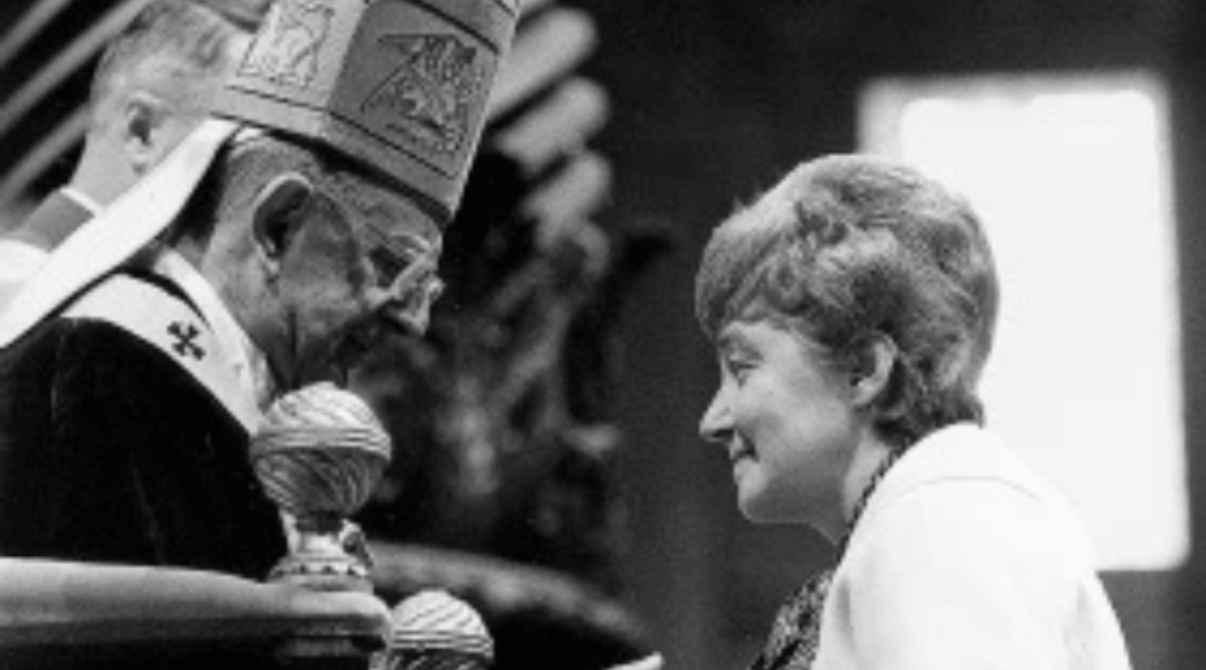 black and white photo of a priest and a woman